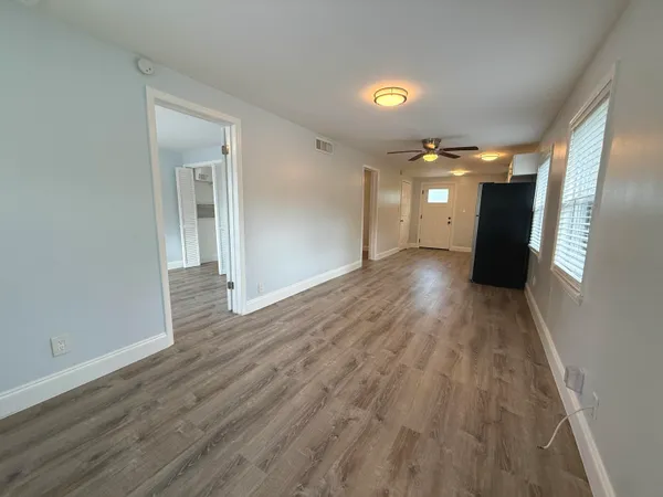 a view of a hallway with wooden floor