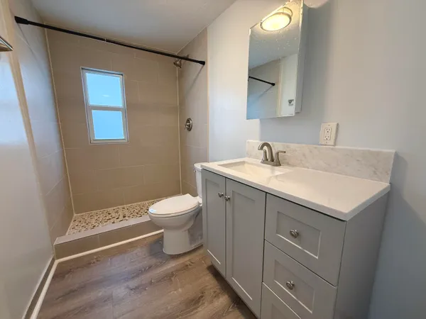 a bathroom with a sink toilet and shower