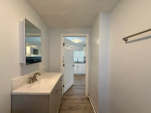 a en suite bathroom with a sink and a mirror