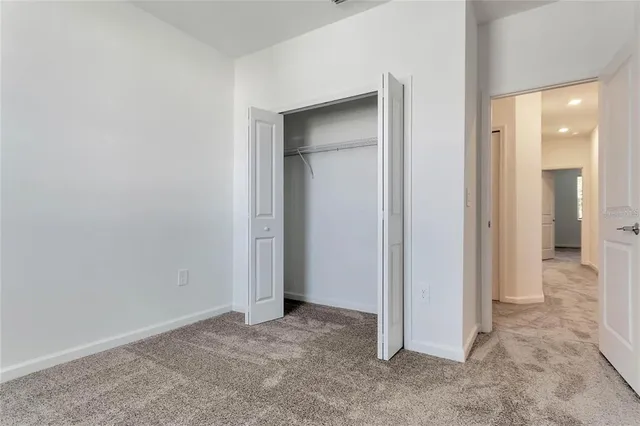 an empty room with closet and a bathroom