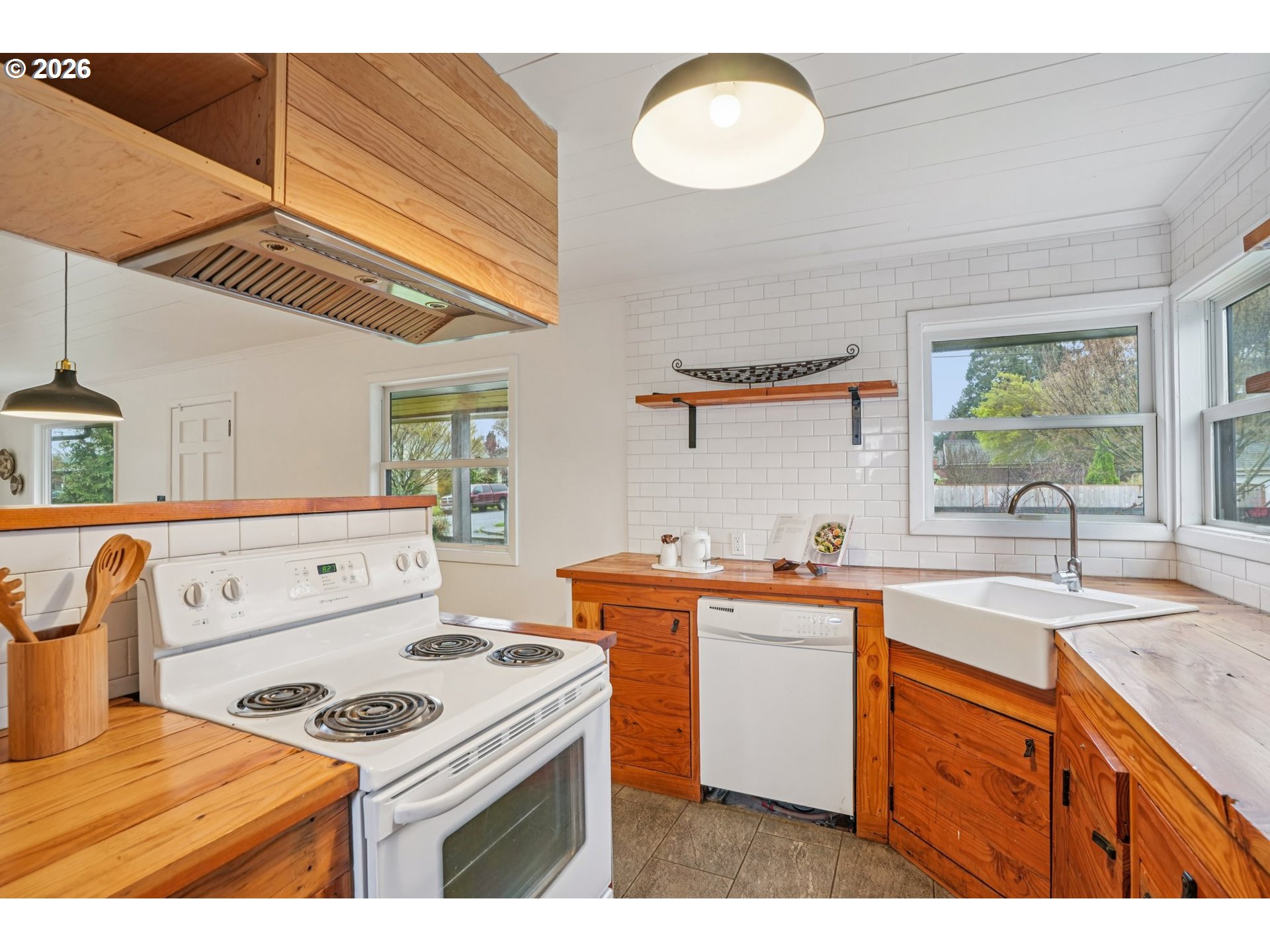 7921 Northeast Clackamas Street Portland, OR 97213 - Photo 11 of 31 a kitchen with a stove a sink and a refrigerator