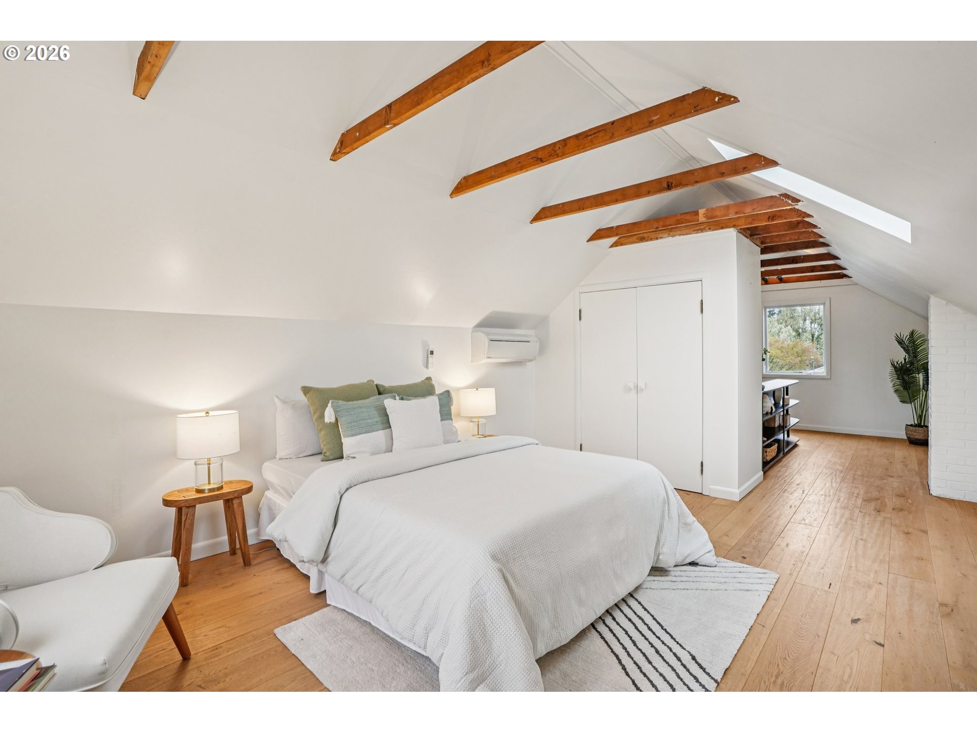 7921 Northeast Clackamas Street Portland, OR 97213 - Photo 21 of 31 a bedroom with a bed and wooden floor
