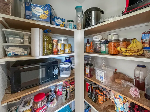 a kitchen with stainless steel appliances granite countertop a lot of clutter and cabinets
