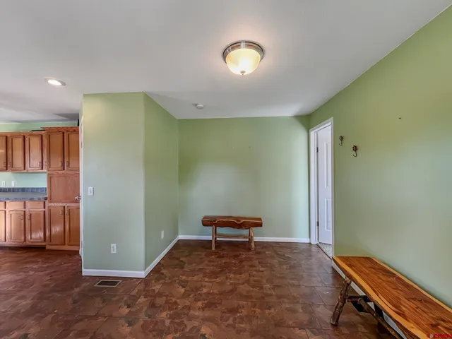 a view of a room with a piano and wooden floor