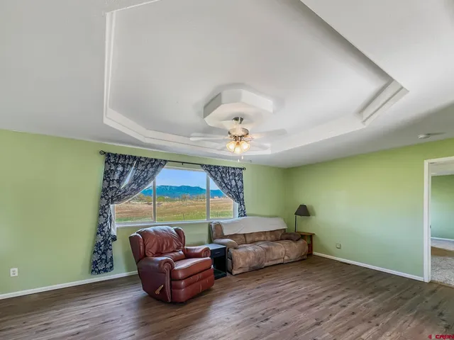 a living room with a couch and a ceiling fan