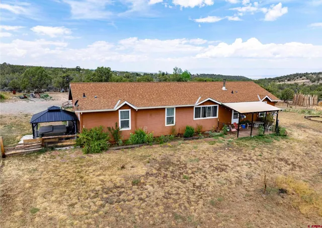 an aerial view of a house with a big yard