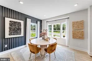 a dining room with furniture window and wooden floor