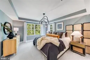 a bed room with a bed mirror and a window