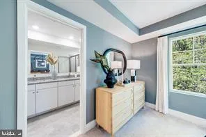 a room with a sink and mirror