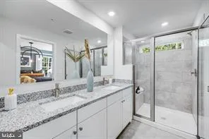 a bathroom with a granite countertop sink mirror and double