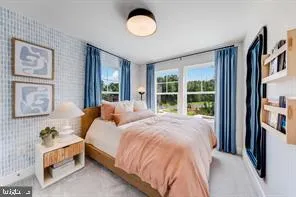 a bed sitting in a bedroom next to a window