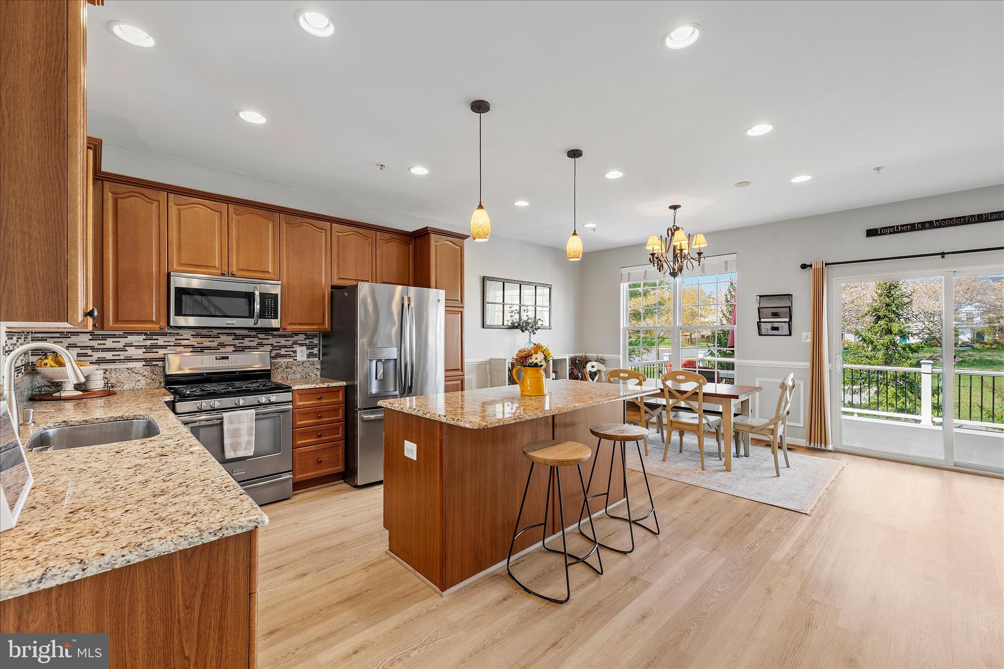 4840 Marsden Place Frederick, MD 21703 - Photo 11 of 46 a kitchen with stainless steel appliances granite countertop sink stove refrigerator dining table and chairs