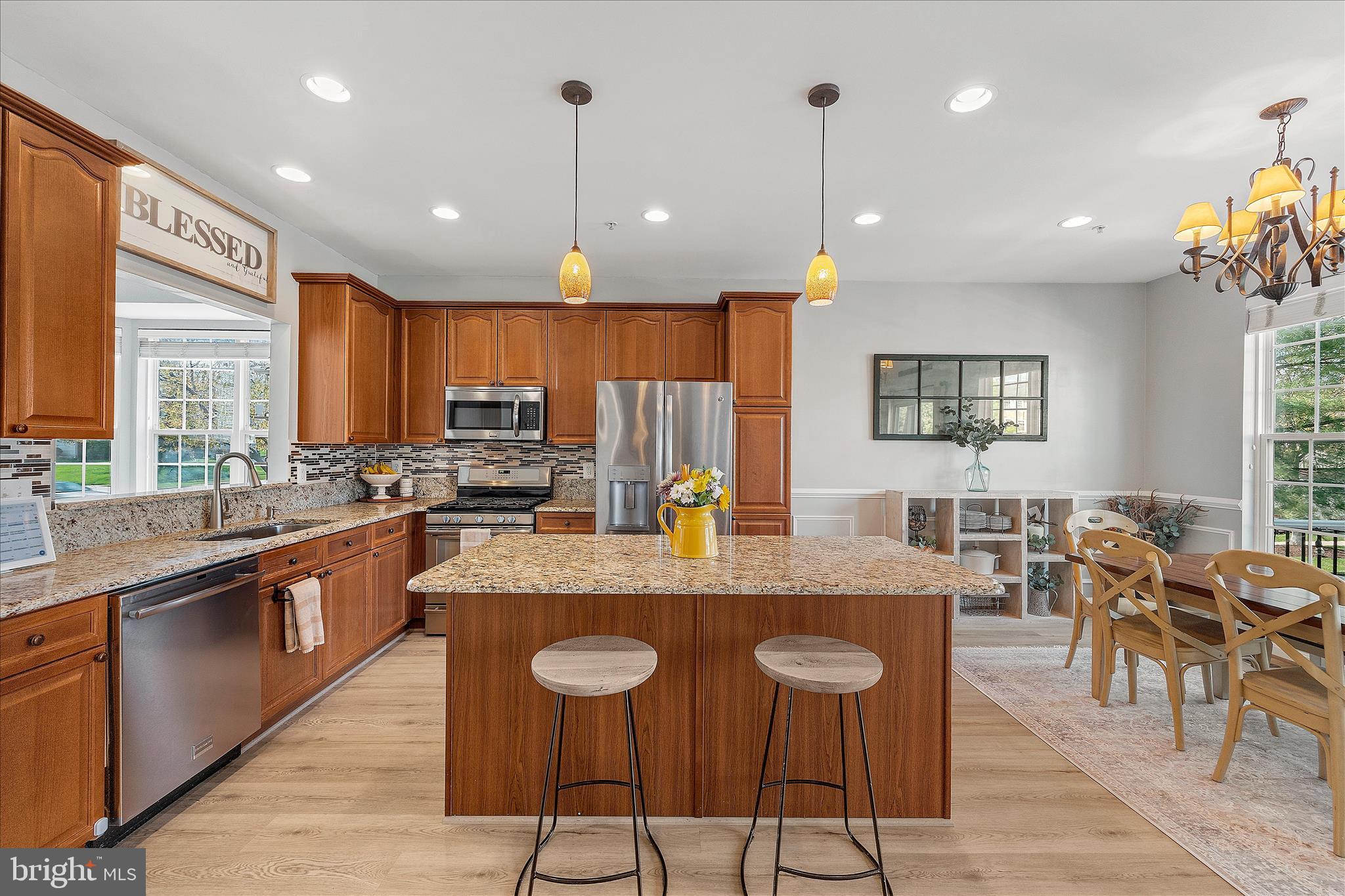 4840 Marsden Place Frederick, MD 21703 - Photo 12 of 46 a large kitchen with kitchen island a dining table and a large window