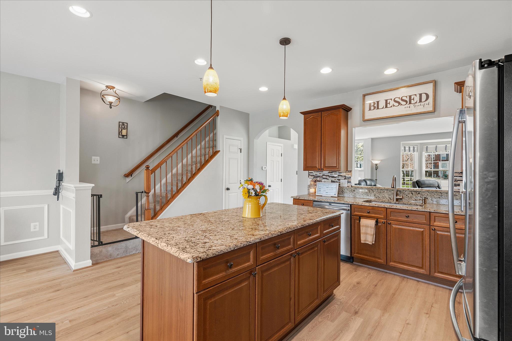 4840 Marsden Place Frederick, MD 21703 - Photo 14 of 46 a kitchen with stainless steel appliances granite countertop counter space a sink and wooden floor