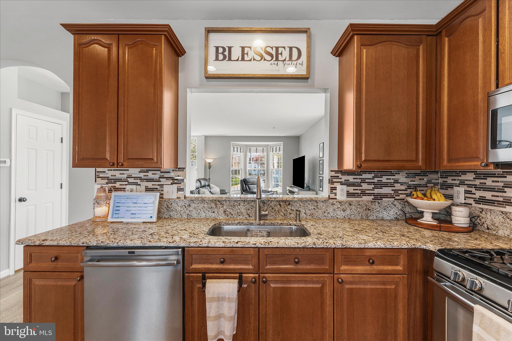 4840 Marsden Place Frederick, MD 21703 - Photo 15 of 46 a kitchen with granite countertop a sink stove and cabinets