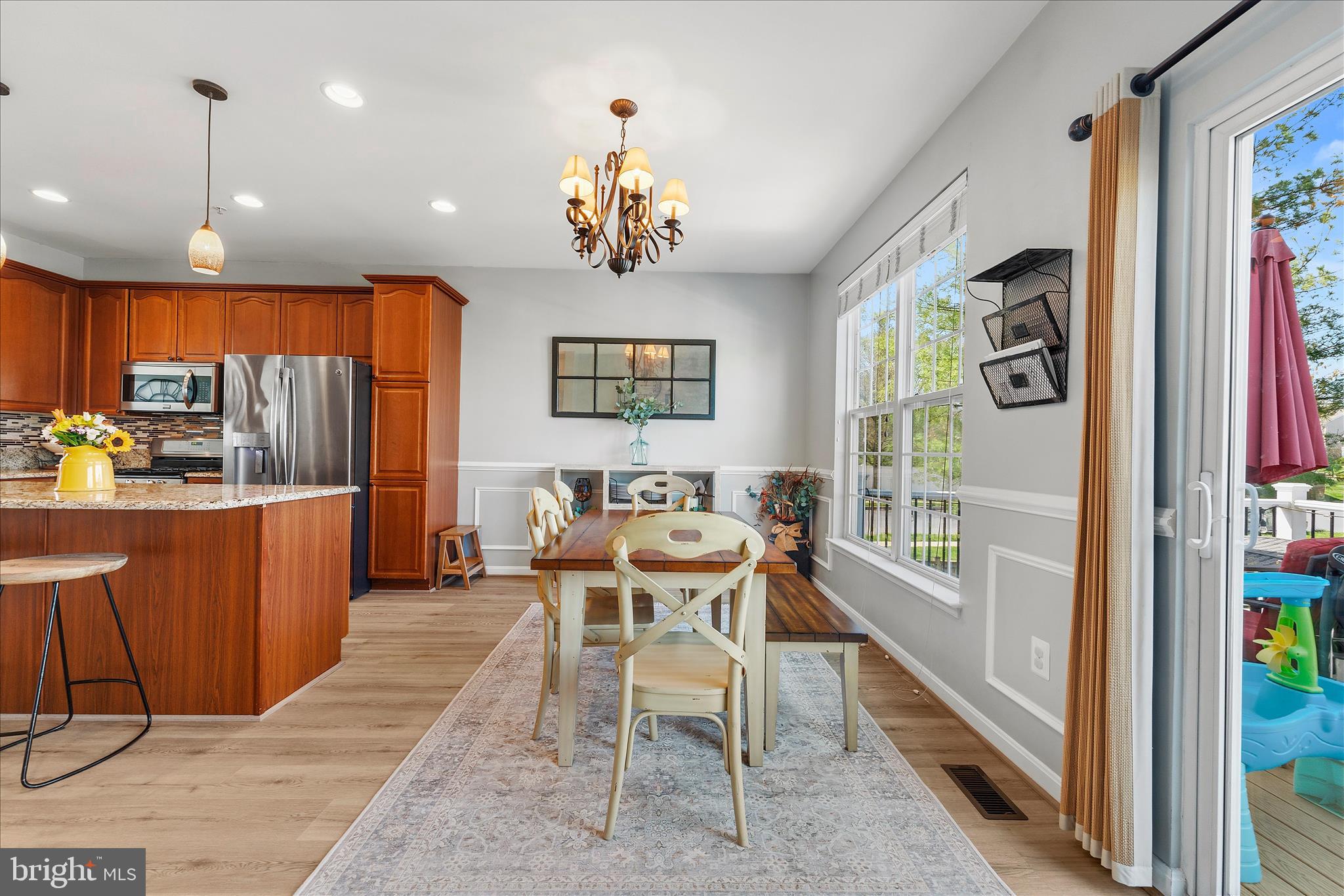 4840 Marsden Place Frederick, MD 21703 - Photo 16 of 46 a view of a dining room with furniture a chandelier and wooden floor