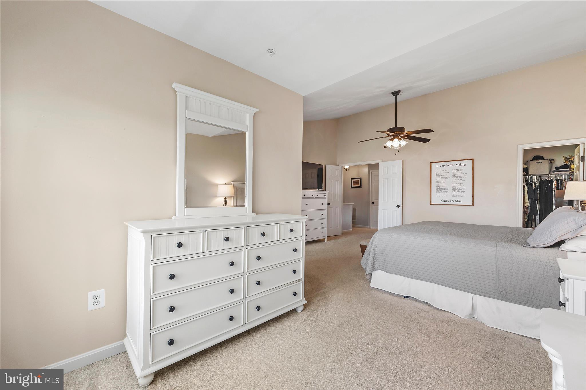 4840 Marsden Place Frederick, MD 21703 - Photo 28 of 46 a bedroom with a bed a chandelier and a dresser