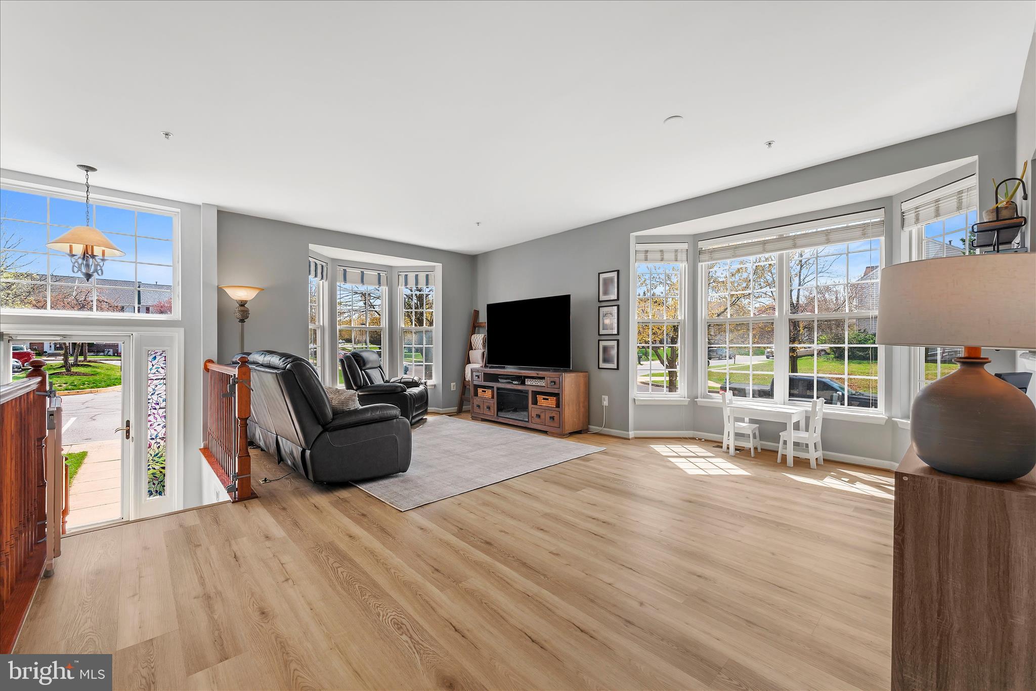 4840 Marsden Place Frederick, MD 21703 - Photo 5 of 46 a living room with furniture a flat screen tv and a floor to ceiling window