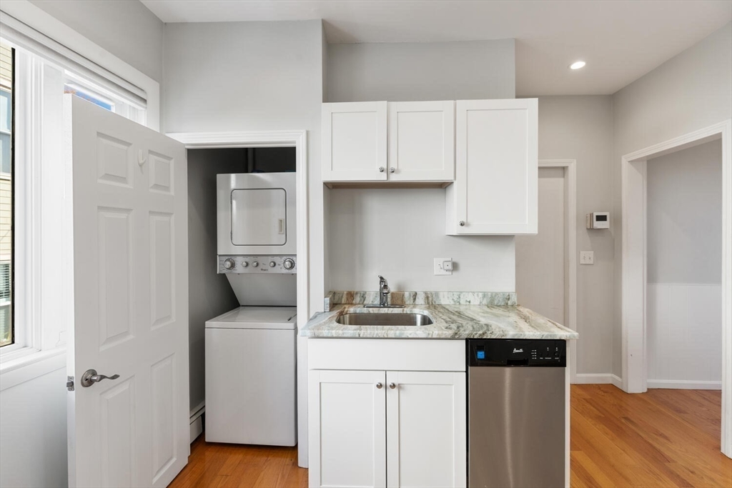 6-8 School Street Boston, MA 02129 - Photo 11 of 27 a kitchen with white cabinets and sink