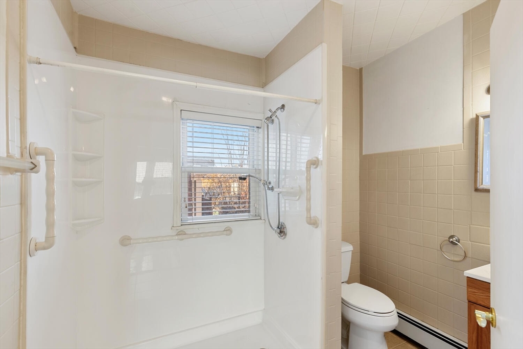 6-8 School Street Boston, MA 02129 - Photo 12 of 27 a white toilet sitting next to a bathroom sink