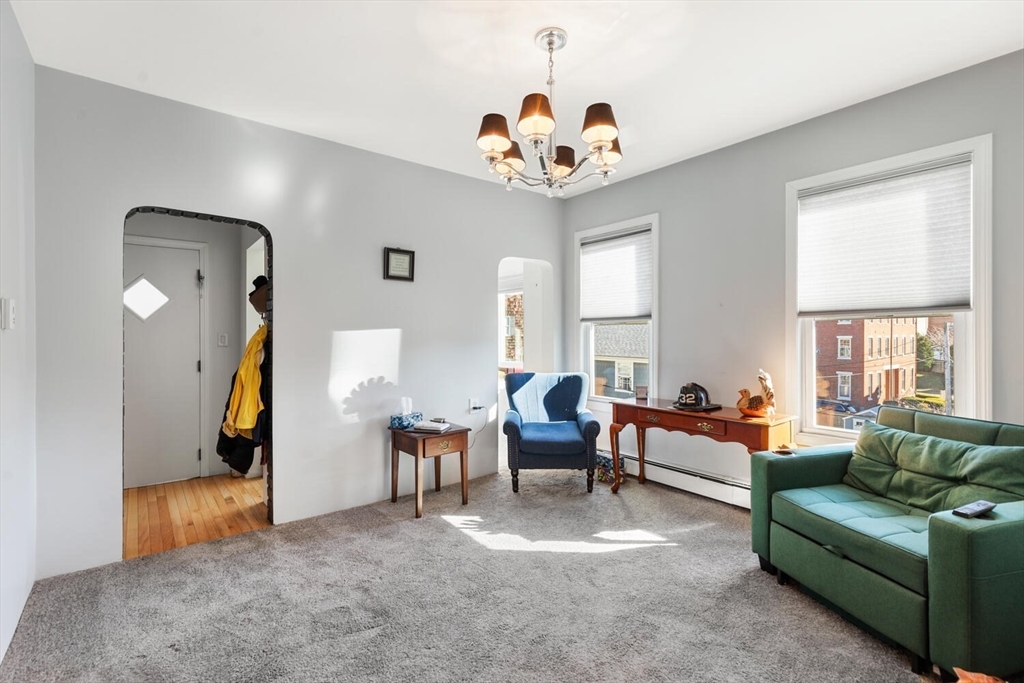 6-8 School Street Boston, MA 02129 - Photo 18 of 27 a living room with furniture and a chandelier