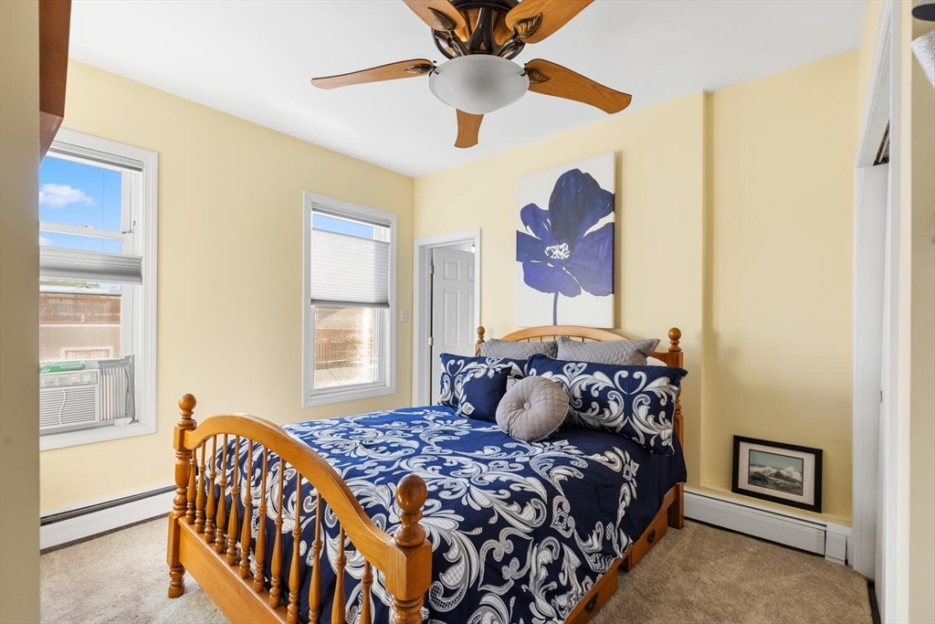6-8 School Street Boston, MA 02129 - Photo 19 of 27 a bedroom with a bed and a chandelier