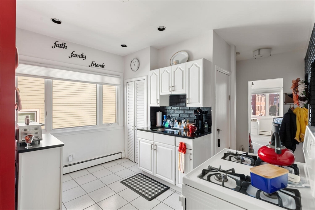 6-8 School Street Boston, MA 02129 - Photo 21 of 27 a kitchen with stainless steel appliances kitchen island granite countertop a stove and a refrigerator