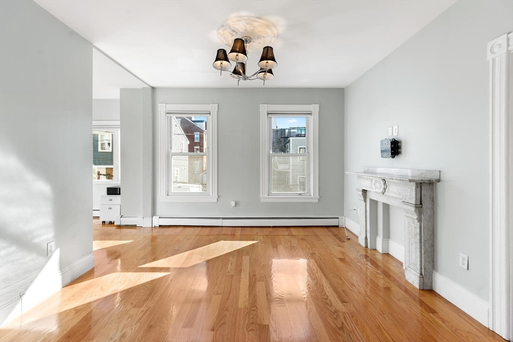 6-8 School Street Boston, MA 02129 - Photo 3 of 27 a view of an empty room with a window and wooden floor