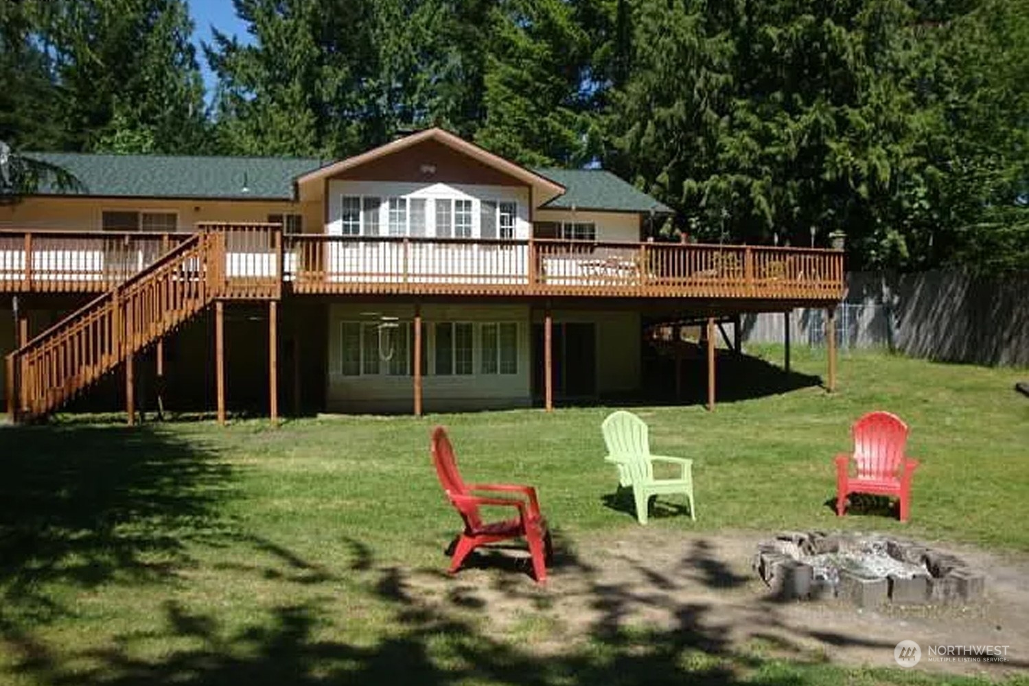 1551 East Loop Road Stevenson, WA 98648 - Photo 1 of 19 a front view of a house with a yard table and chairs