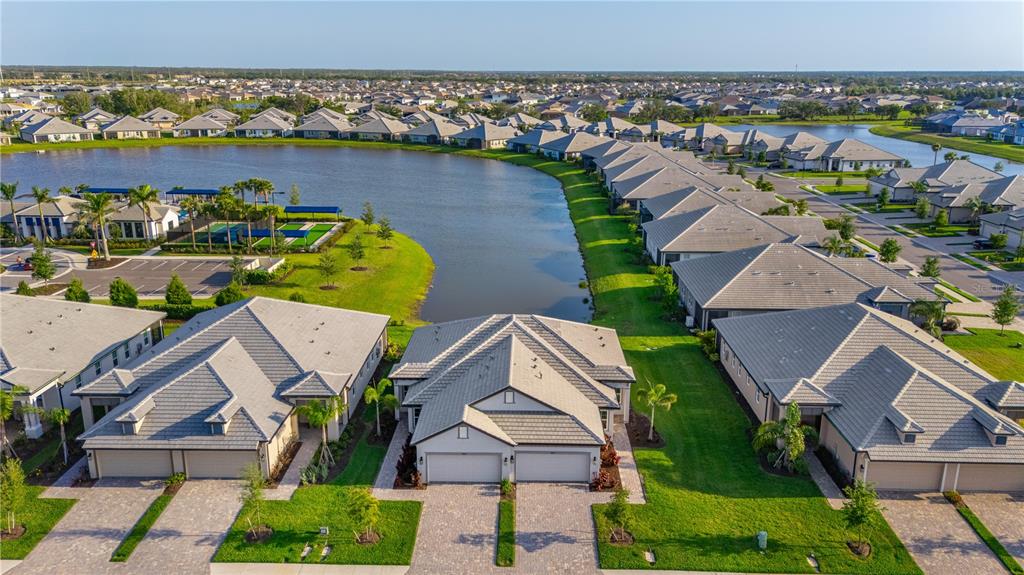 an aerial view of residential houses with outdoor space and swimming pool
