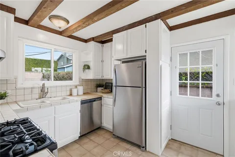a kitchen with a sink appliances and cabinets