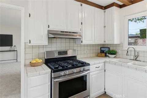 a kitchen with stainless steel appliances granite countertop a sink a stove and a granite counter tops