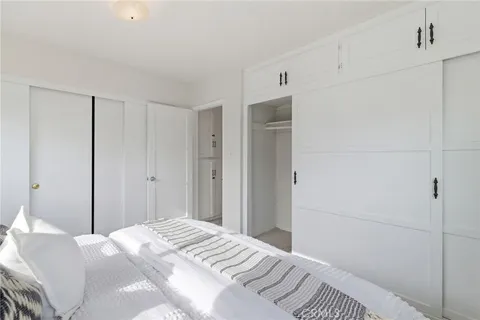 a bedroom with a bed and a closet