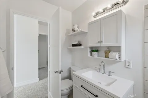 a bathroom with a sink toilet vanity and tub