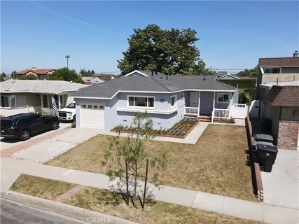 an aerial view of a house with yard and parking
