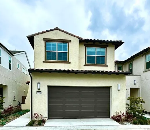 a front view of a house with garage