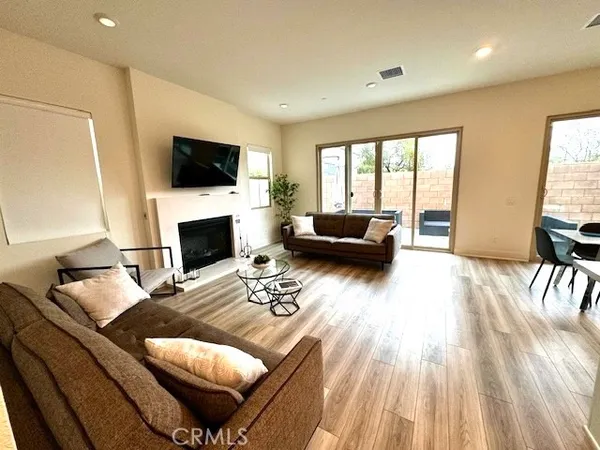 a living room with furniture fireplace and a flat screen tv