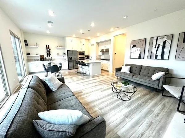 a living room with furniture and a dining table