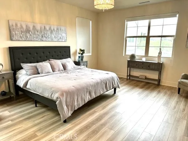 a bedroom with a bed and window