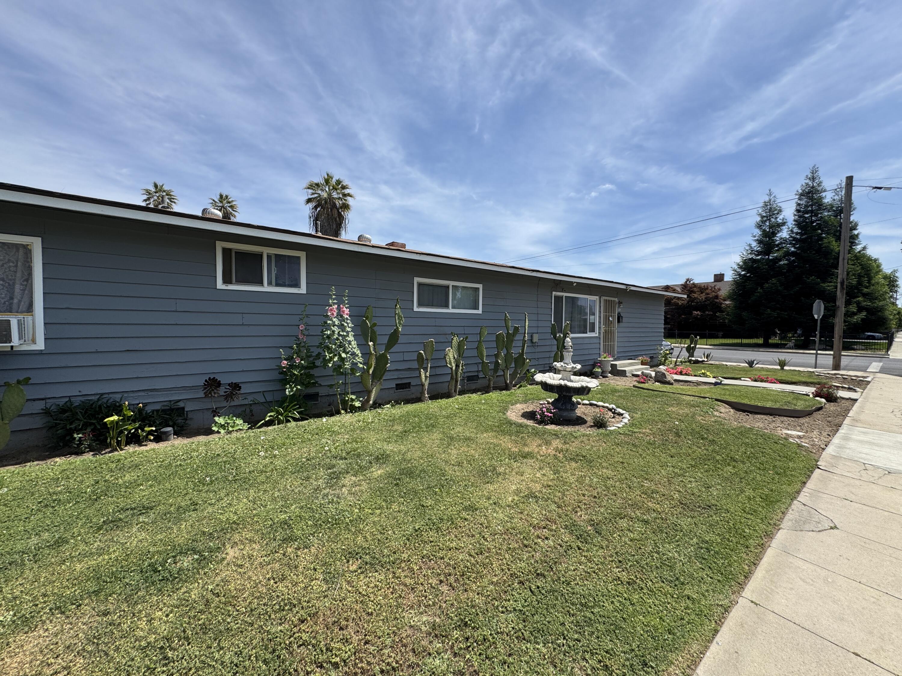 704 North Floral Street Visalia, CA 93291 - Photo 32 of 51 a view of swimming pool with outdoor seating and yard