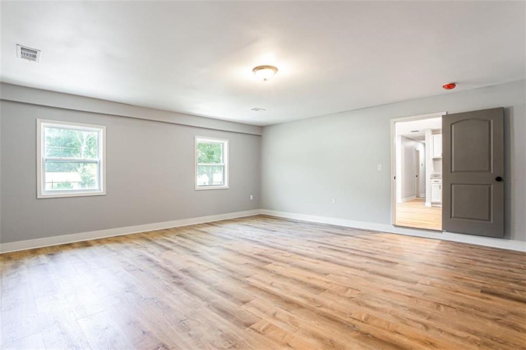 3652 Sweetbriar Circle Lithia Springs, GA 30122 - Photo 15 of 30 a view of an empty room with wooden floor and a window