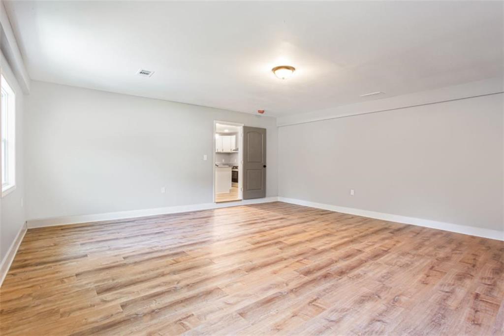 3652 Sweetbriar Circle Lithia Springs, GA 30122 - Photo 16 of 30 a view of an empty room with wooden floor