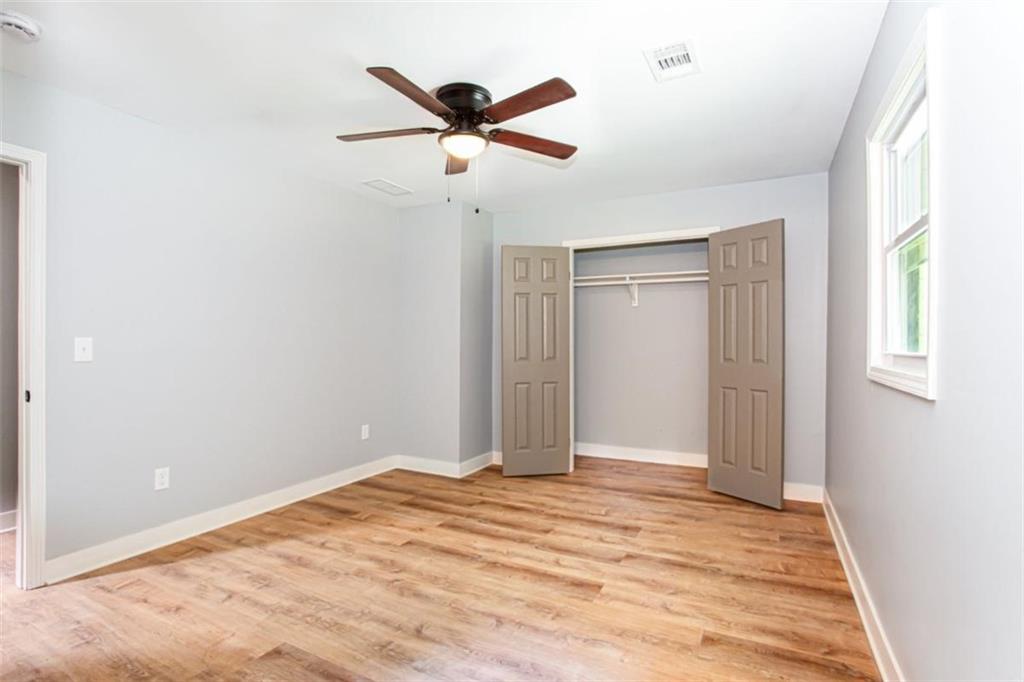 3652 Sweetbriar Circle Lithia Springs, GA 30122 - Photo 20 of 30 a view of a livingroom with a ceiling fan & wooden floor