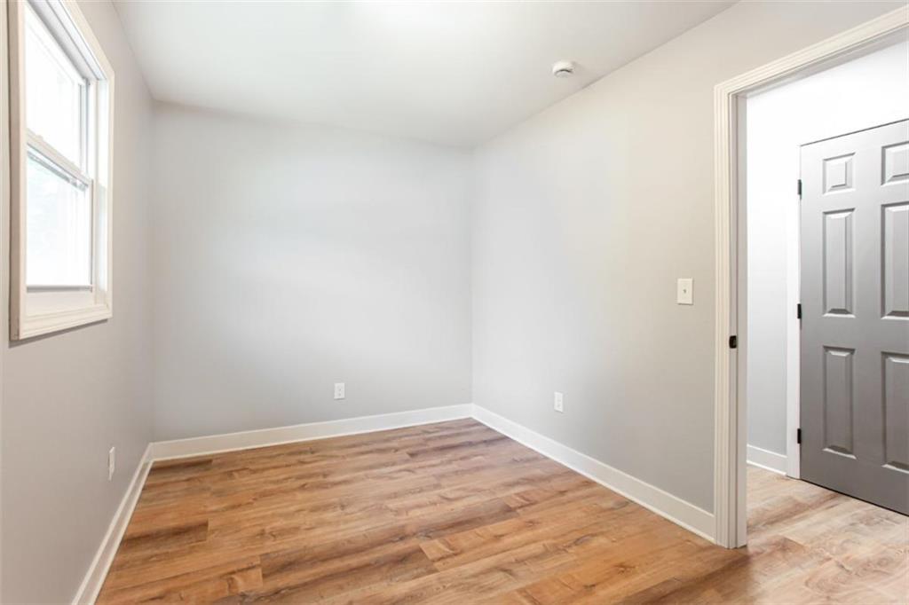 3652 Sweetbriar Circle Lithia Springs, GA 30122 - Photo 22 of 30 an empty room with wooden floor and windows