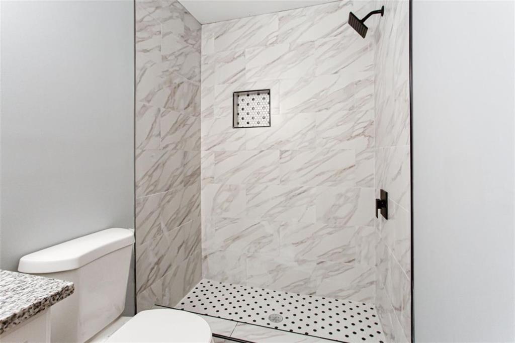 3652 Sweetbriar Circle Lithia Springs, GA 30122 - Photo 23 of 30 a bathroom with a toilet and a shower