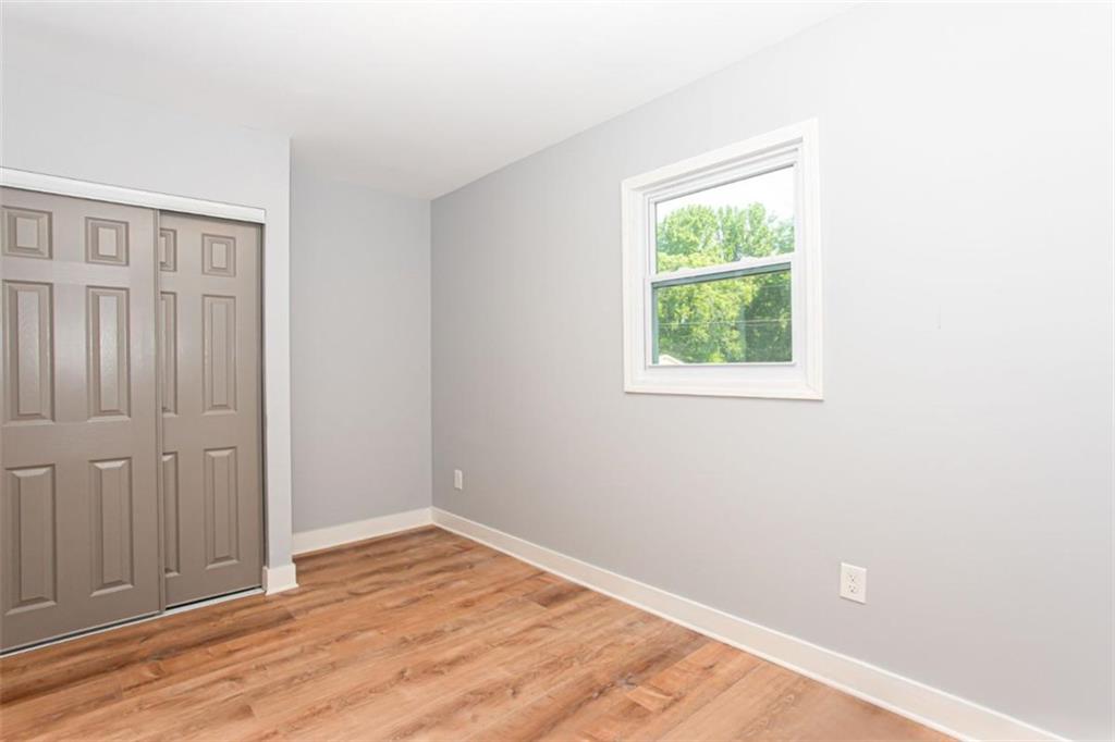 3652 Sweetbriar Circle Lithia Springs, GA 30122 - Photo 24 of 30 an empty room with wooden floor and windows