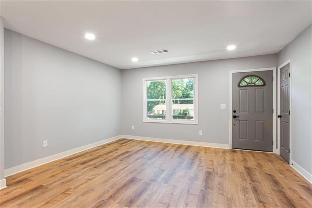 3652 Sweetbriar Circle Lithia Springs, GA 30122 - Photo 9 of 30 wooden floor in an empty room with a window
