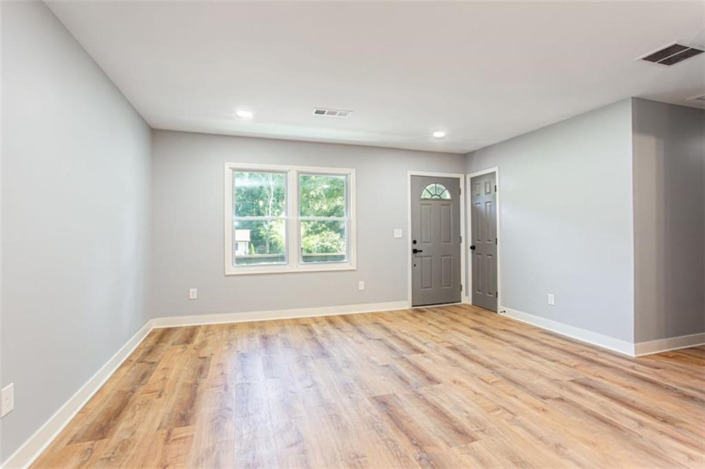 3652 Sweetbriar Circle Lithia Springs, GA 30122 - Photo 10 of 30 a view of empty room with wooden floor and fan