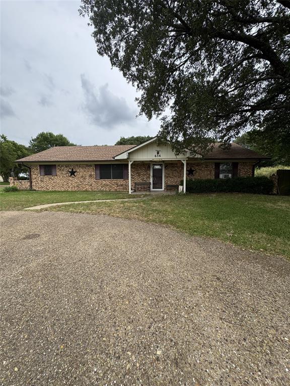 Ranch-style residence featuring a brick exterior and a covered front porch