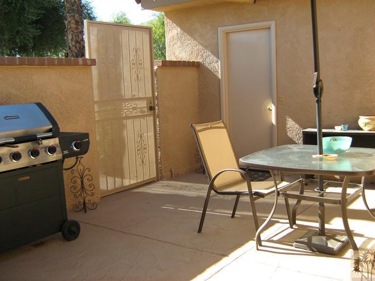 58 Majorca Drive Rancho Mirage, CA 92270 - Photo 17 of 22 a view of a patio with table and chairs and potted plants